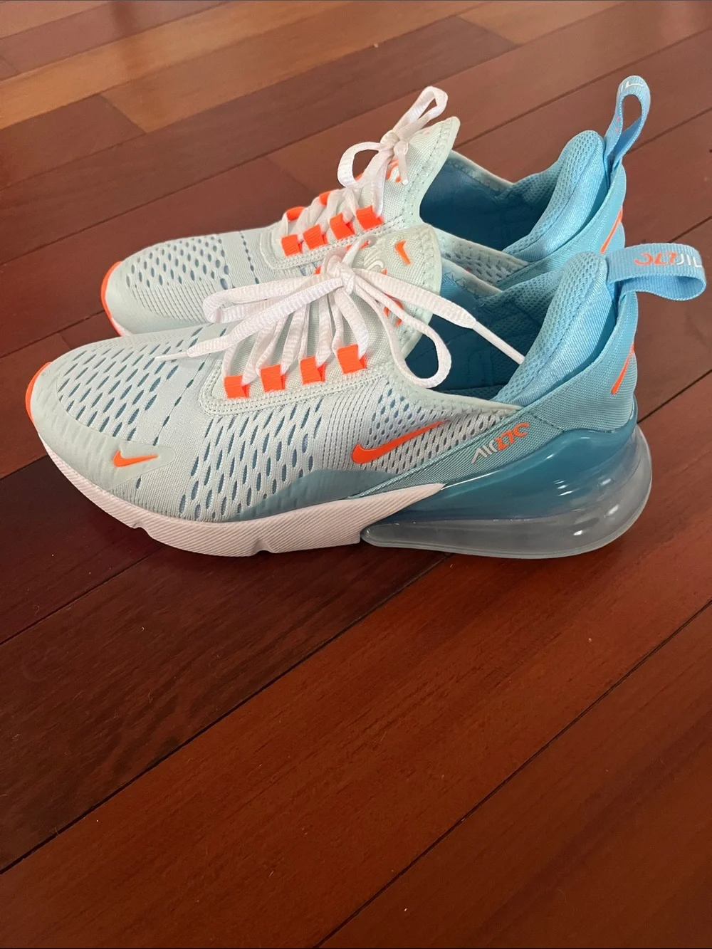 Nike Women’s Light Blue Sneakers with Orange Accents